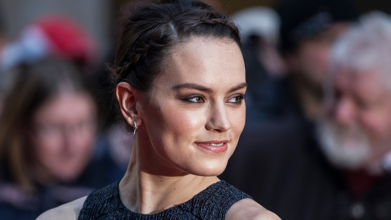 Daisy Ridley poses in a black dress