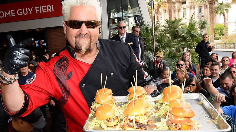 Guy Fieri with tray of burgers 