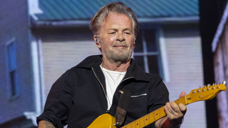 John Mellencamp holding a guitar
