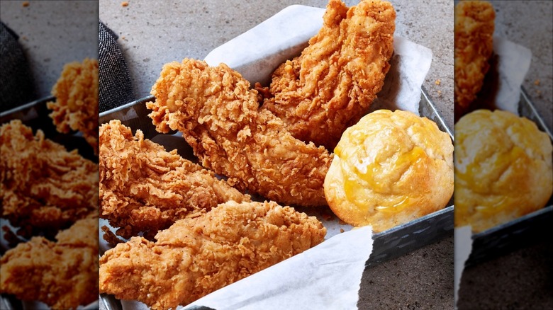 An order of Krispy Krunchy Chicken tenders on a tray with a hot roll