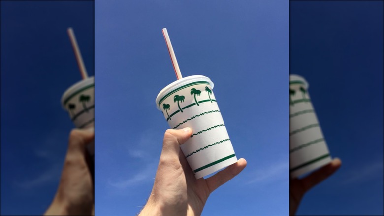 In-N-Out shake held against blue sky