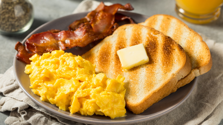 Scrambled eggs, bacon, and toast