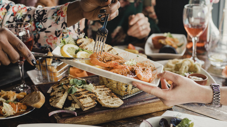 Friends sharing at a seafood restaurant
