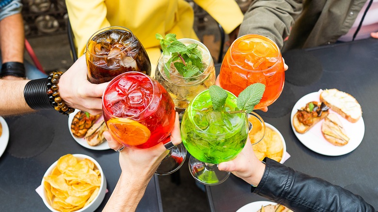 a toast with colorful drinks