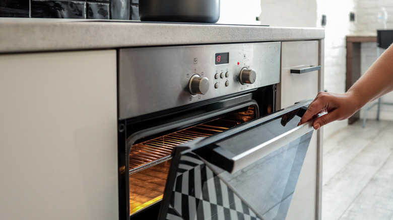 Opening a modern stainless steel oven