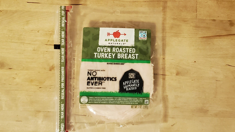a package of Applegate sliced turkey on wooden surface