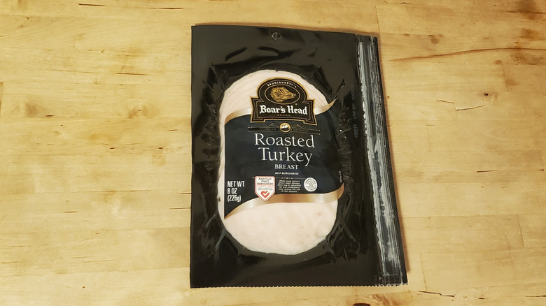a package of Boar's Head sliced roasted turkey on wooden surface