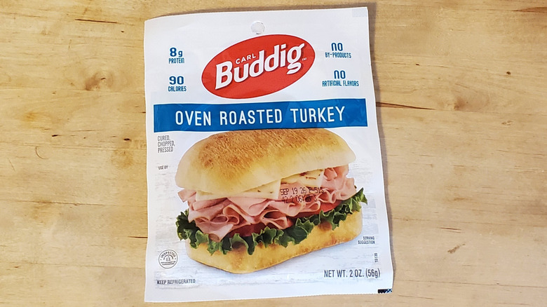 a package of Buddig sliced oven roasted turkey on wooden surface