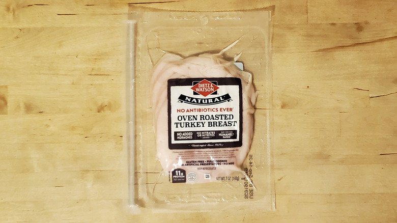 a package of Dietz and Watson sliced oven roasted turkey breast on wooden surface