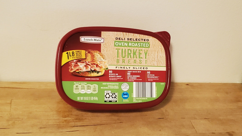 a tub of Lunch Mate sliced turkey from Aldi on wooden surface