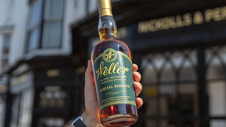 A hand holding a bottle of Weller Special Reserve outdoors