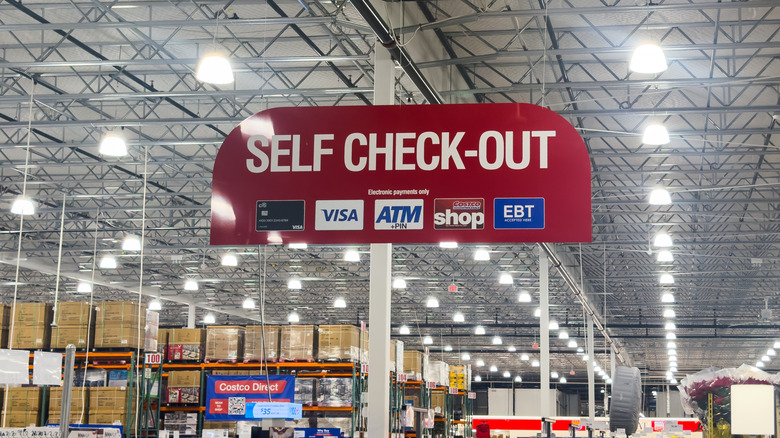 Costco self checkout sign inside store