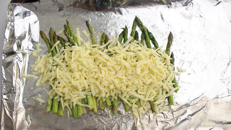 Asparagus and cheese on foil-covered tray