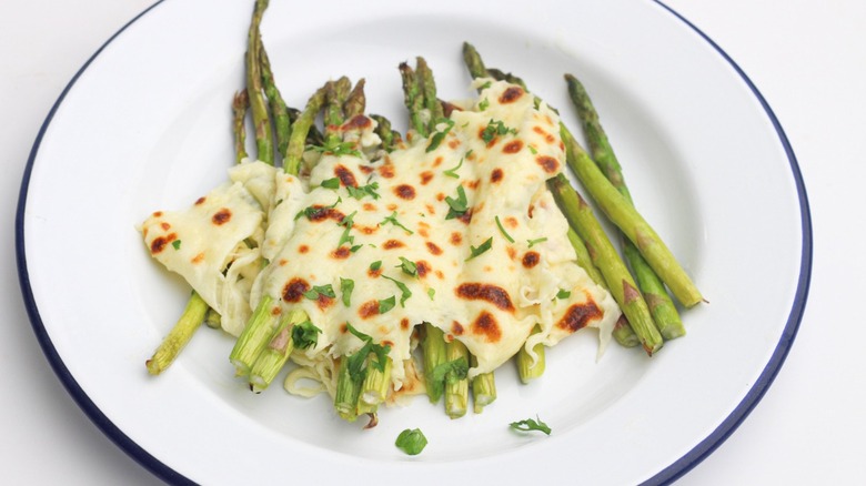 Cheese-topped asparagus on plate