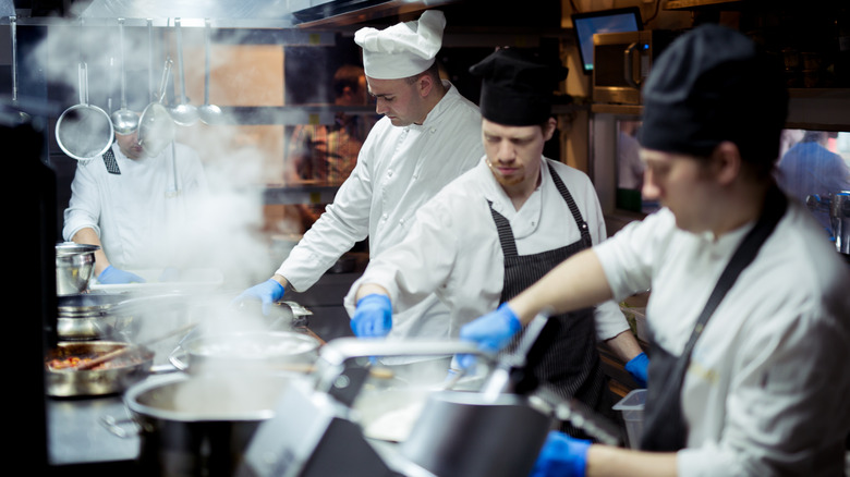 Busy chefs working inside a kitchen