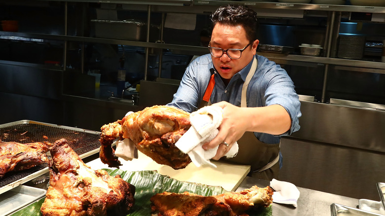 Dale Talde handles roasted meat in kitchen