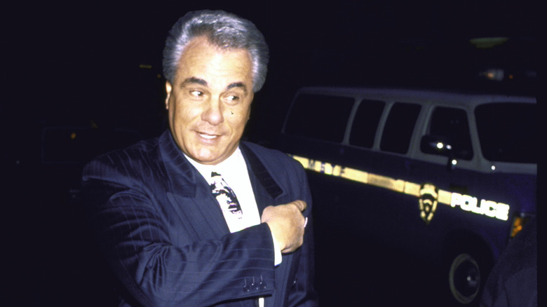 John Gotti near police vehicle