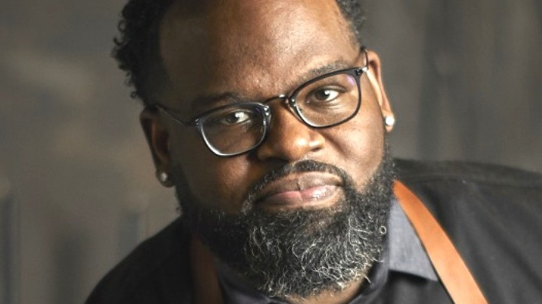 Chef Lamar Moore posing in glasses and apron