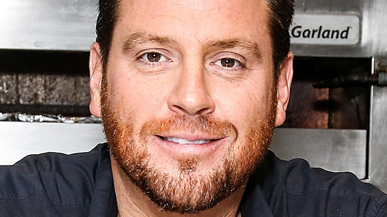 Scott Conant smiling in kitchen