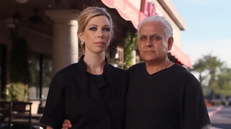 Amy and Samy Bouzaglo posing in front of a restaurant