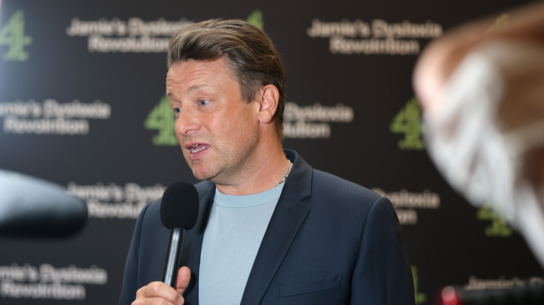 Jamie Oliver giving an interview at a red carpet event