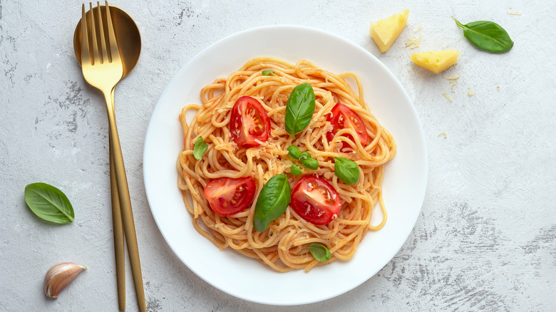 cherry tomato pasta with fork and spoon