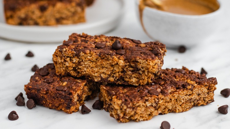 Peanut butter granola bars with bowl of something