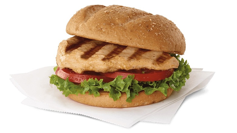 Chick-fil-A grilled chicken sandwich with lettuce and tomato placed on napkin