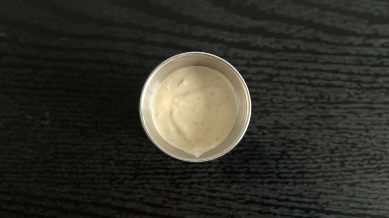 Close-up of small cup with Chick-fil-A Parmesan Caesar salad dressing