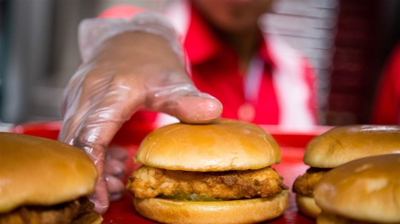 Chick-Fil-A employee with chicken sandwiches