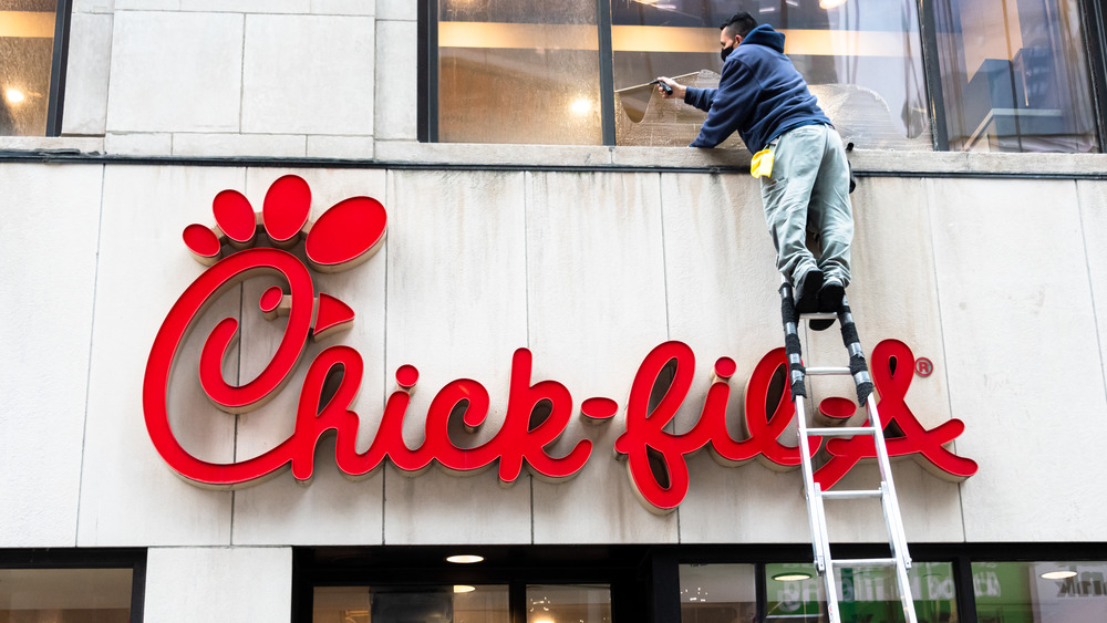 Man cleaning windows of Chick-fil-A