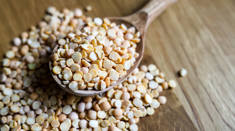 Dried peas on wooden spoon