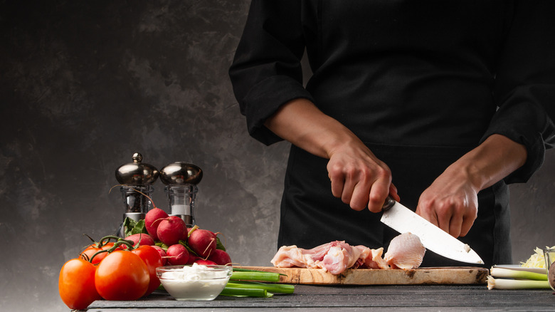 chef prepping chicken and veggies