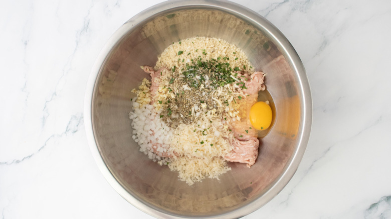 Unmixed chicken meatball ingredients in bowl