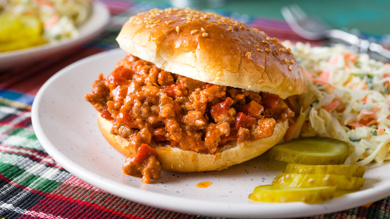 sloppy joe sandwich with pickles and slaw
