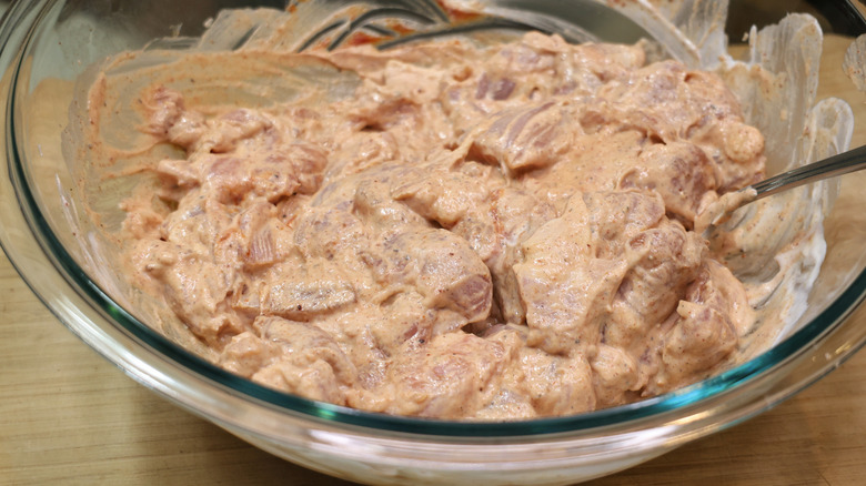 bowl of cubed chicken thighs in yogurt marinade