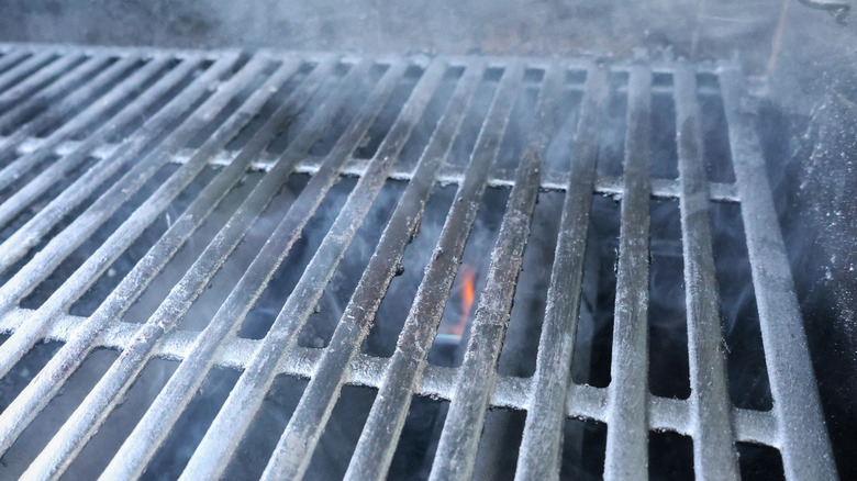 smoking grill grate with fire below