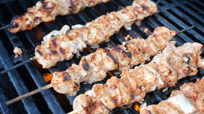 chicken kebabs cooking on the grill