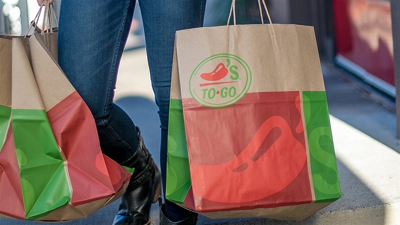 Person carrying Chili's takeout bag