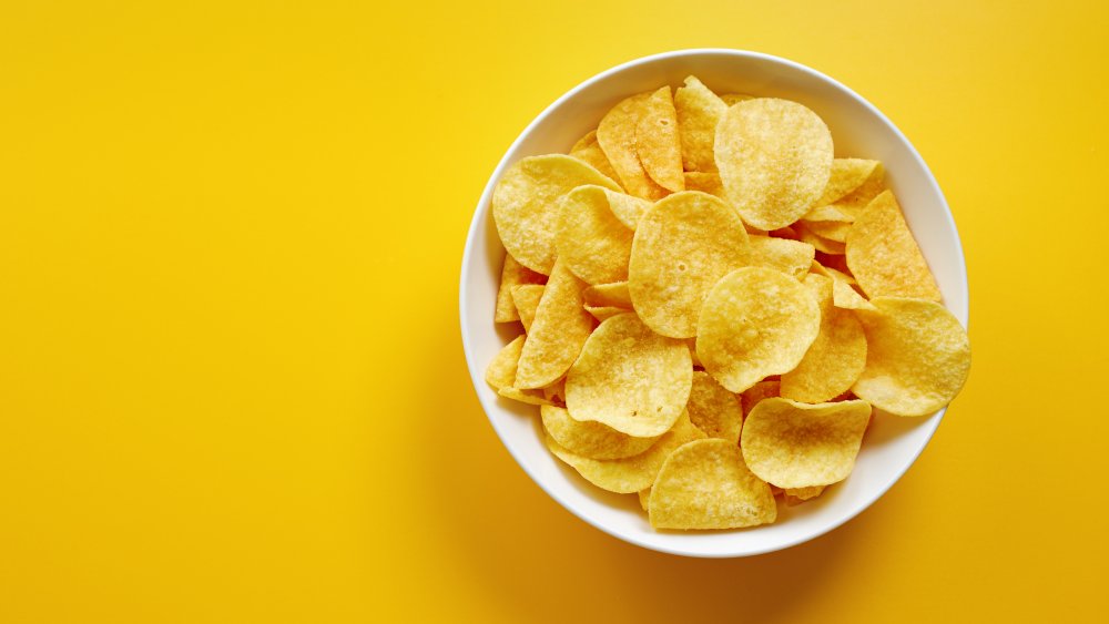 Guy ecstatically pigging out on chips