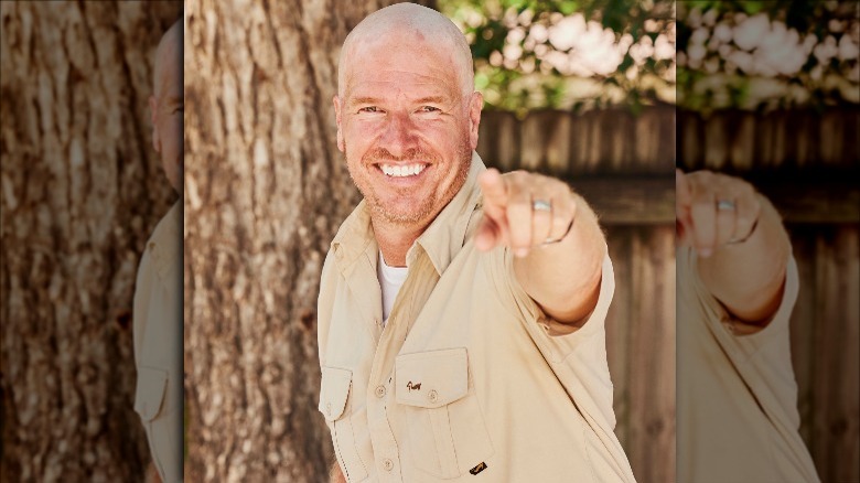 Bald Chip Gaines smiling and pointing