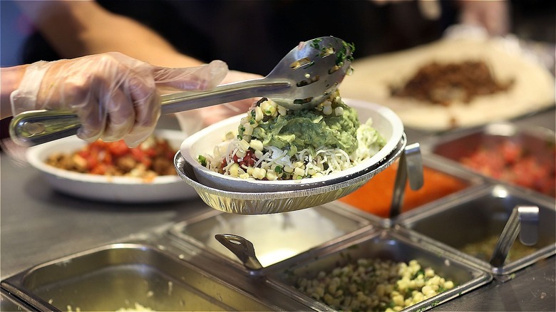 Chipotle worker preparing food