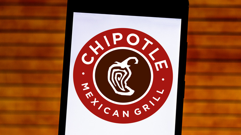 The Chipotle logo on a phone