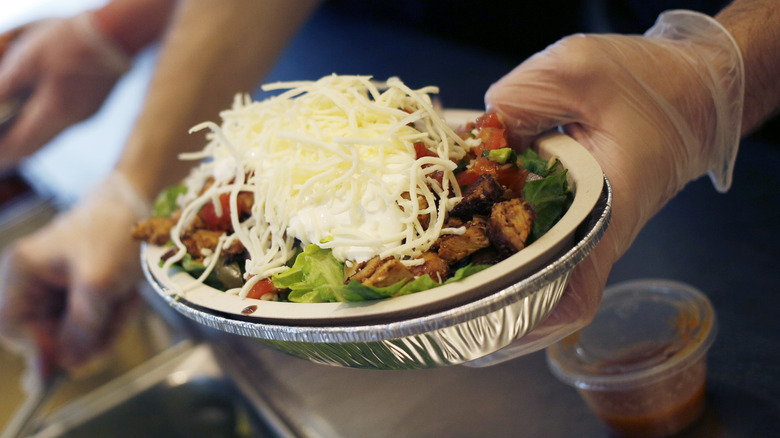 hand holding Chipotle burrito bowl