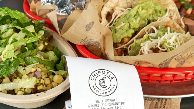 Burrito bowl and tacos with a receipt from Chipotle Mexican Grill