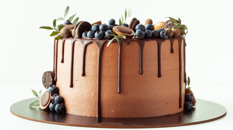 chocolate cake decorated with fruit and flowers