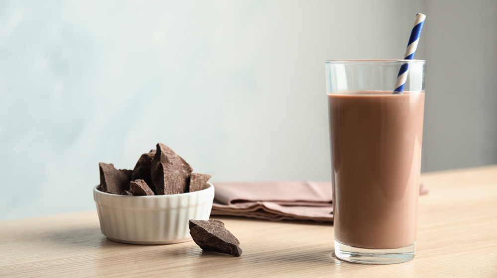 Glass of chocolate milk with straw