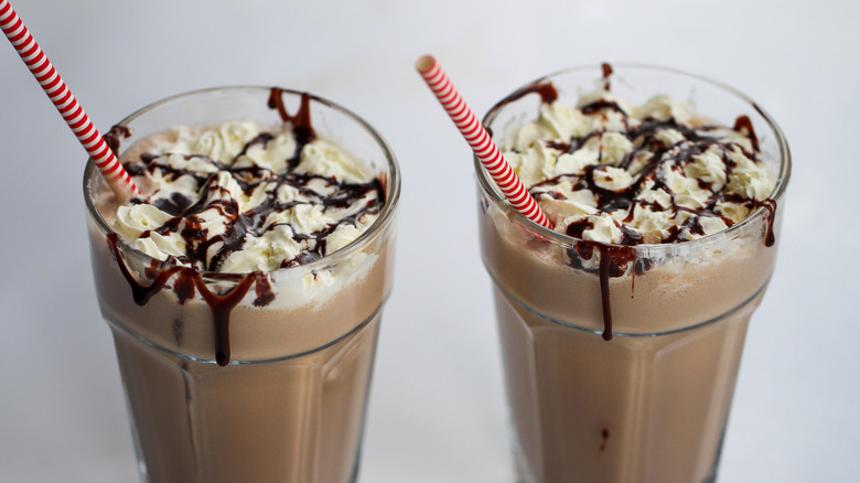 chocolate milkshakes in glasses with straws