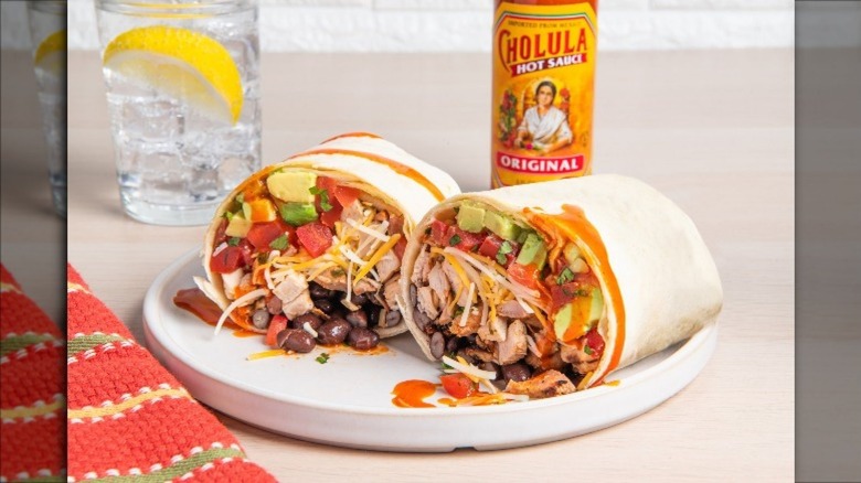 Burrito cross sectioned with cholula hot sauce