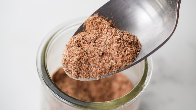 spice mix in spoon over glass jar